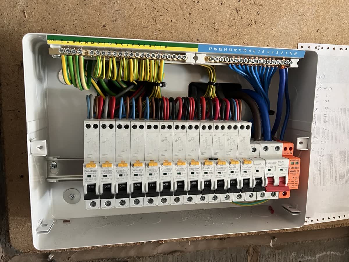 Electrician upgrading a domestic consumer unit and mains board